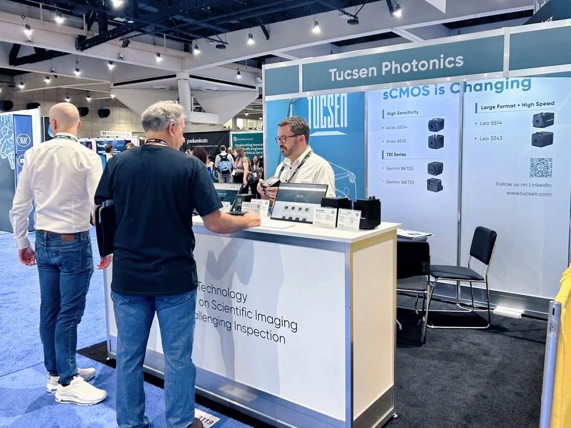 Tucsen Photonics exhibition booth showcasing scientific imaging cameras at a trade show.